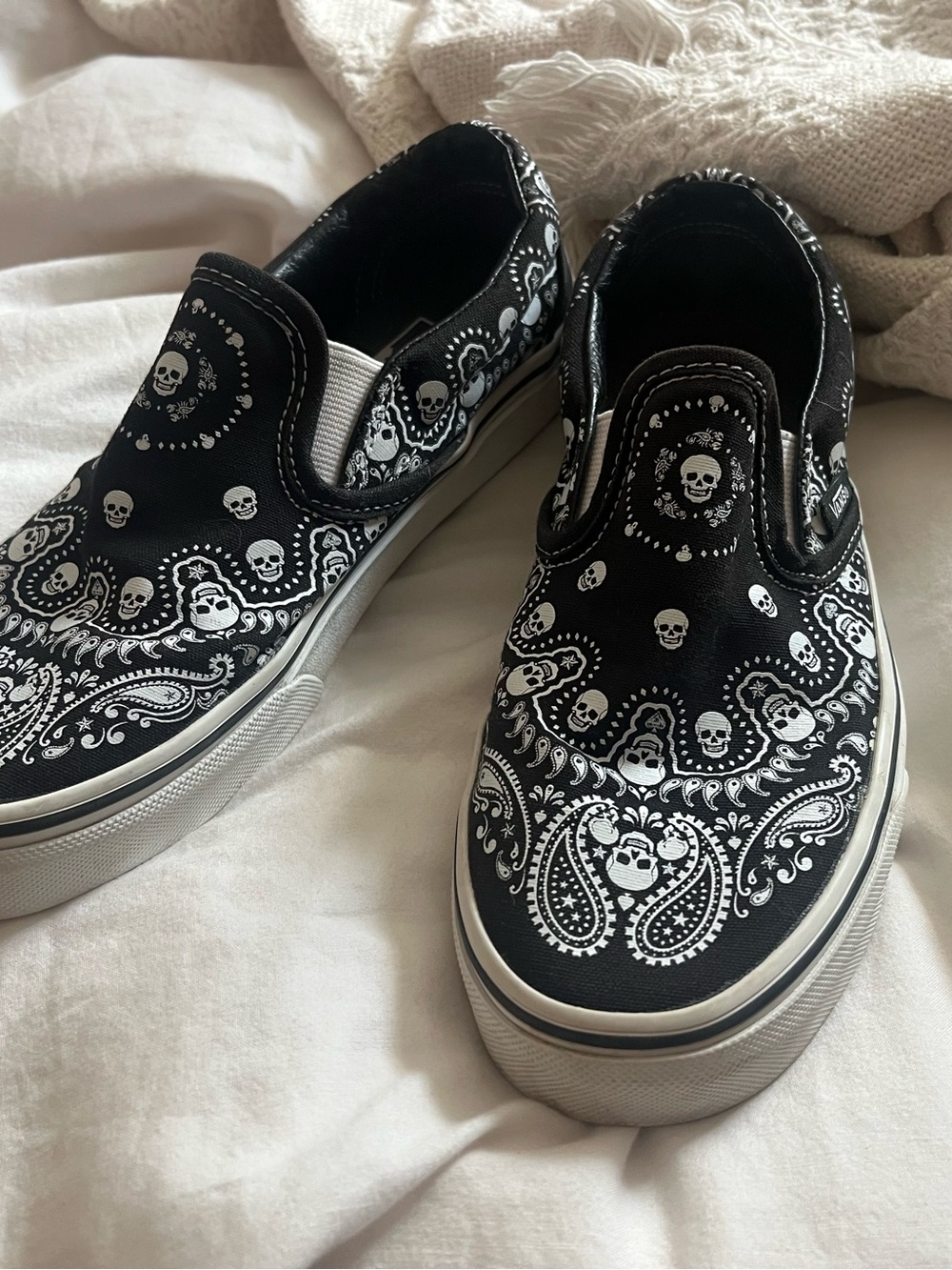 Vans Black Slip-On Sneakers with White Skull Bandana Print